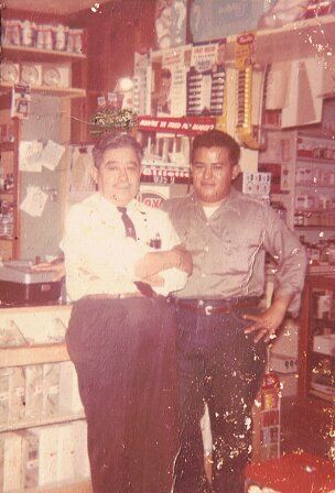 Victor S. Ortiz and Victor C. Ortiz together inside Ortiz Pharmacy, 1960